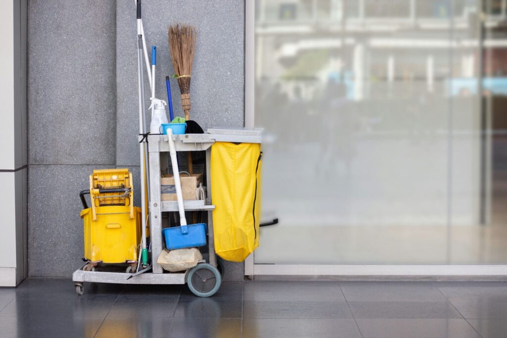 Cleaning contractor cart and mop in a lobby, showing when other parties may also be liable for a fall